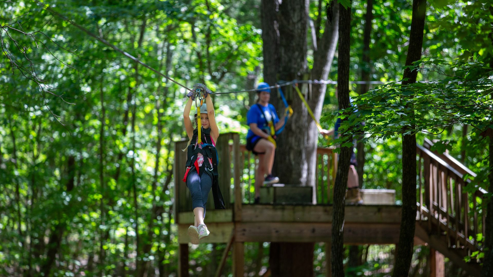 A girl soars along a zip line in St Louis.