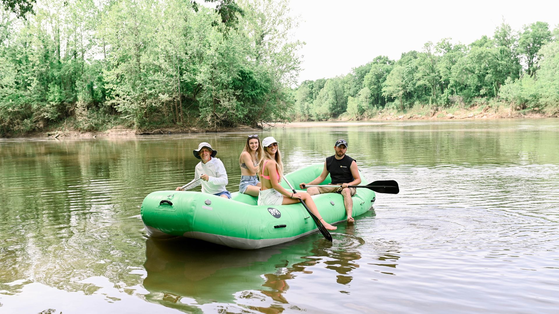 Friends float down the Meramec River in a raft, which is a rite of passage during summer in St Louis.