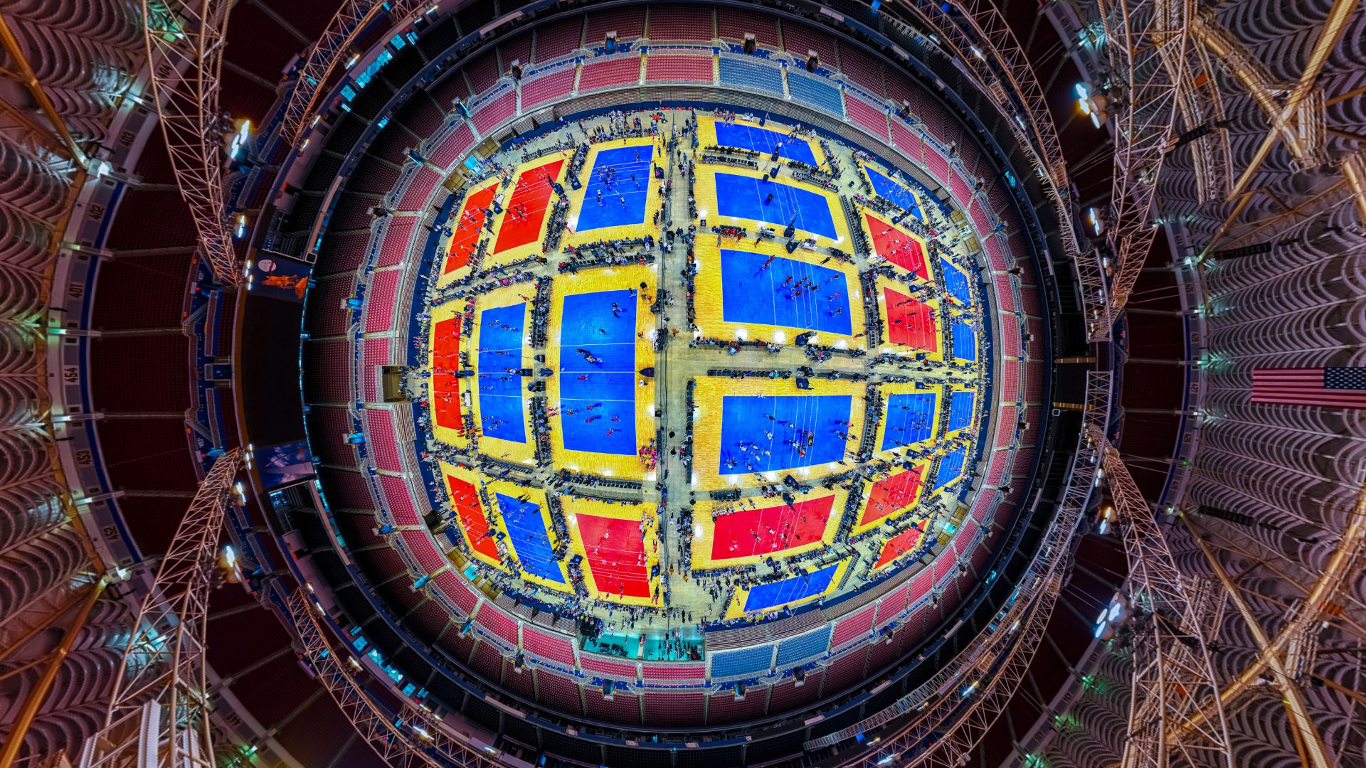 An aerial fish-eye view shows volleyball courts covering the floor of The Dome at America's Center.