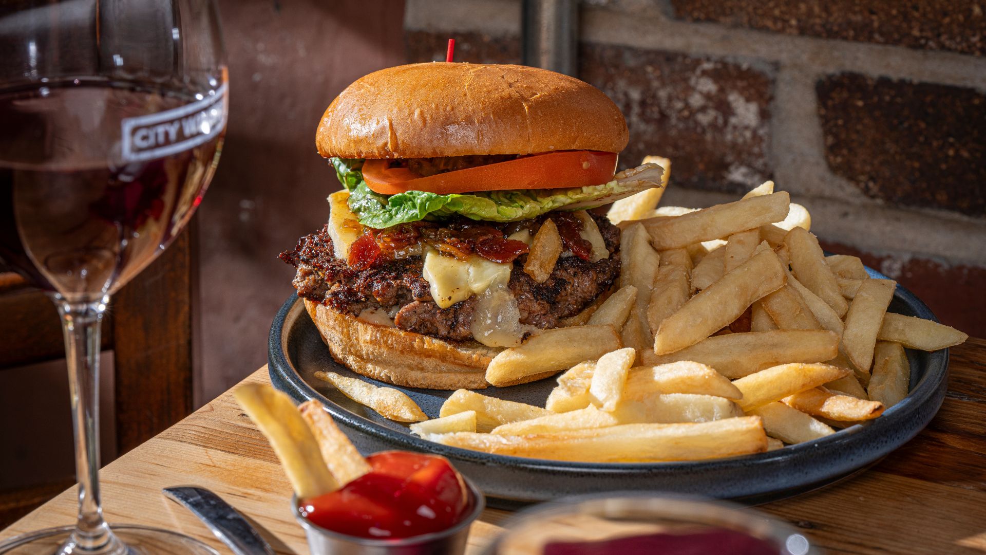 At City Winery St Louis, you can pair house-fermented wine with American-style burgers.