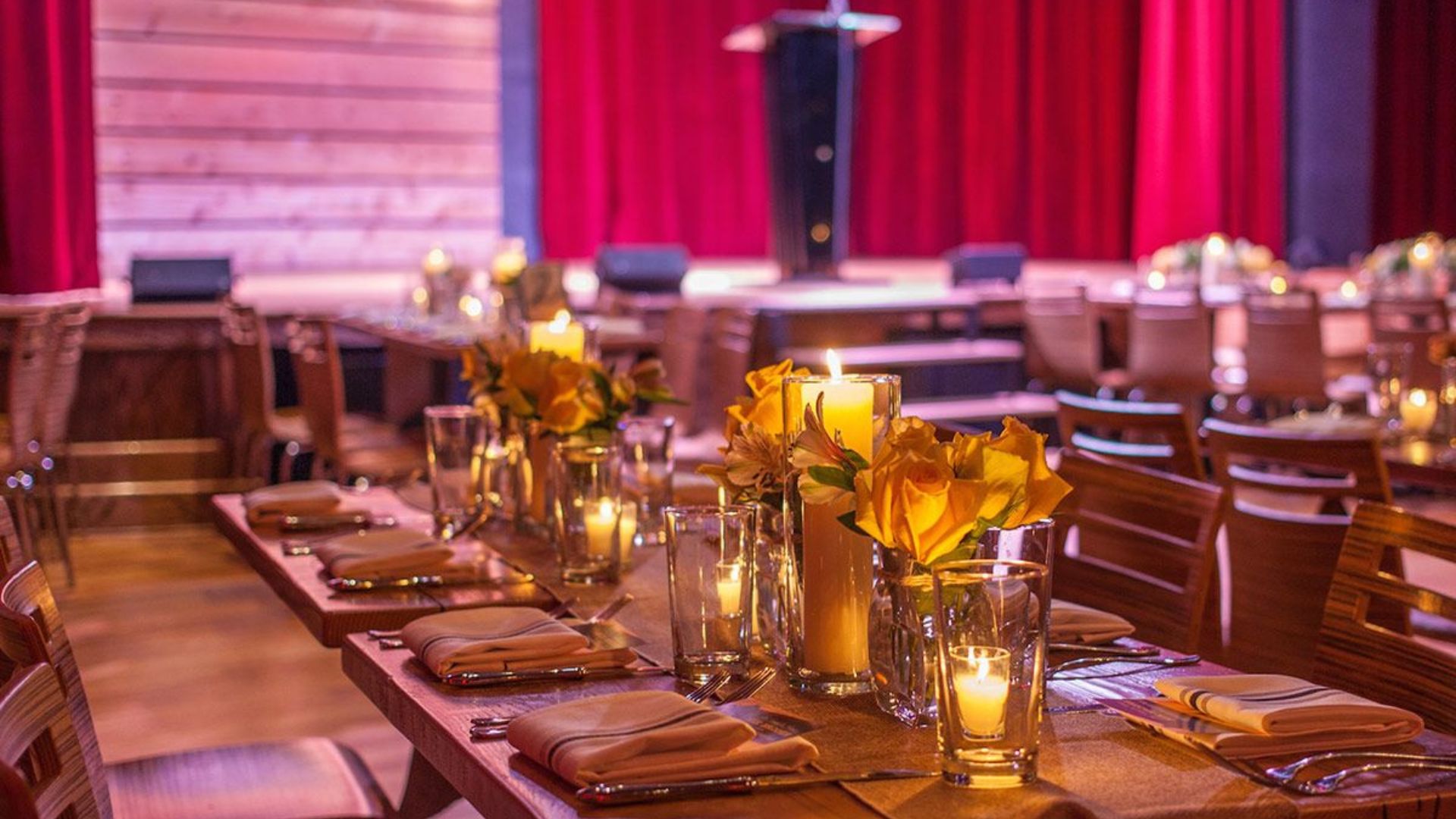 Tables are set with candles for an event at City Winery St Louis.