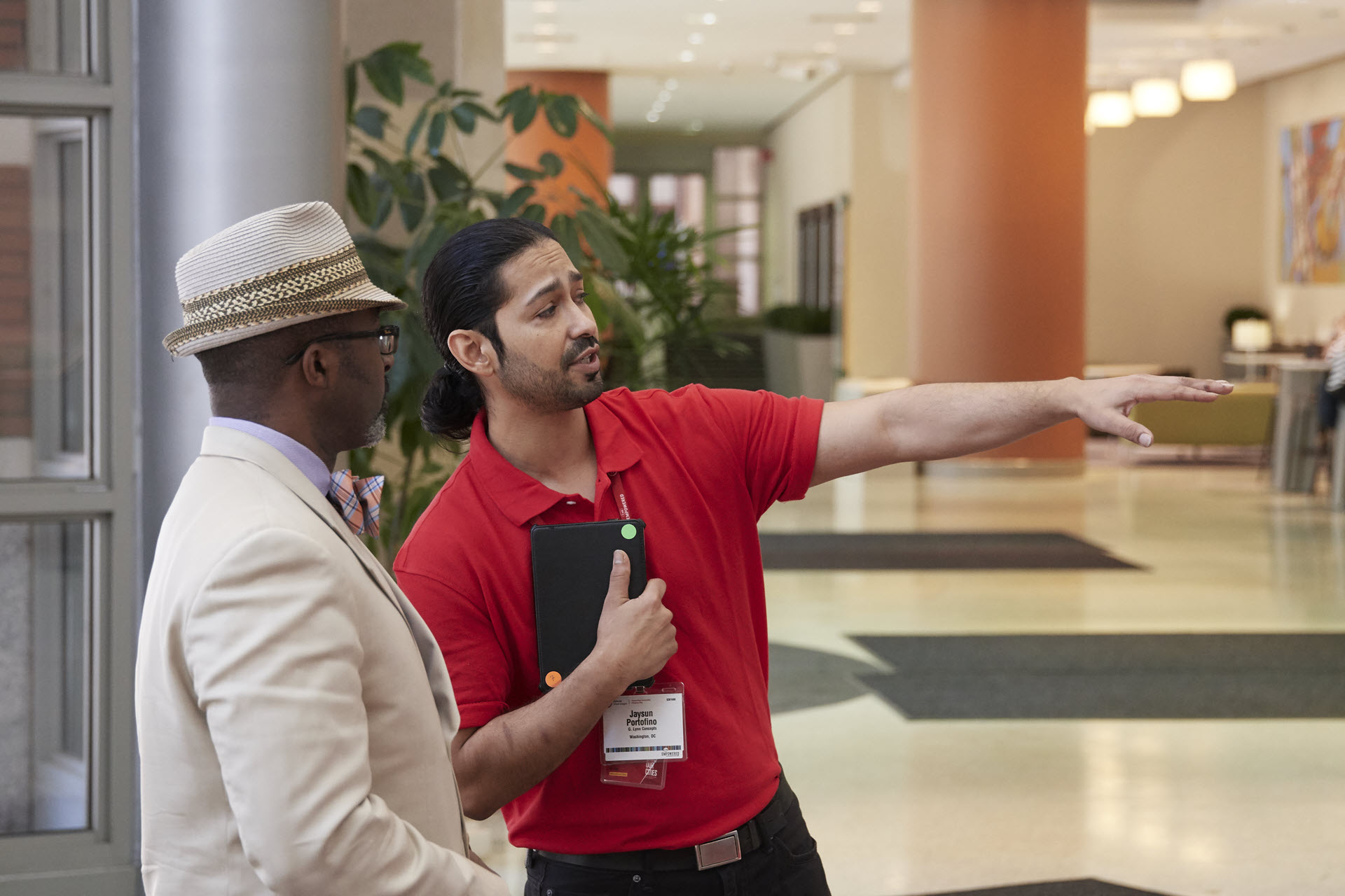 A member of the convention volunteer team provides an attendee with directions at America's Center Convention Complex.