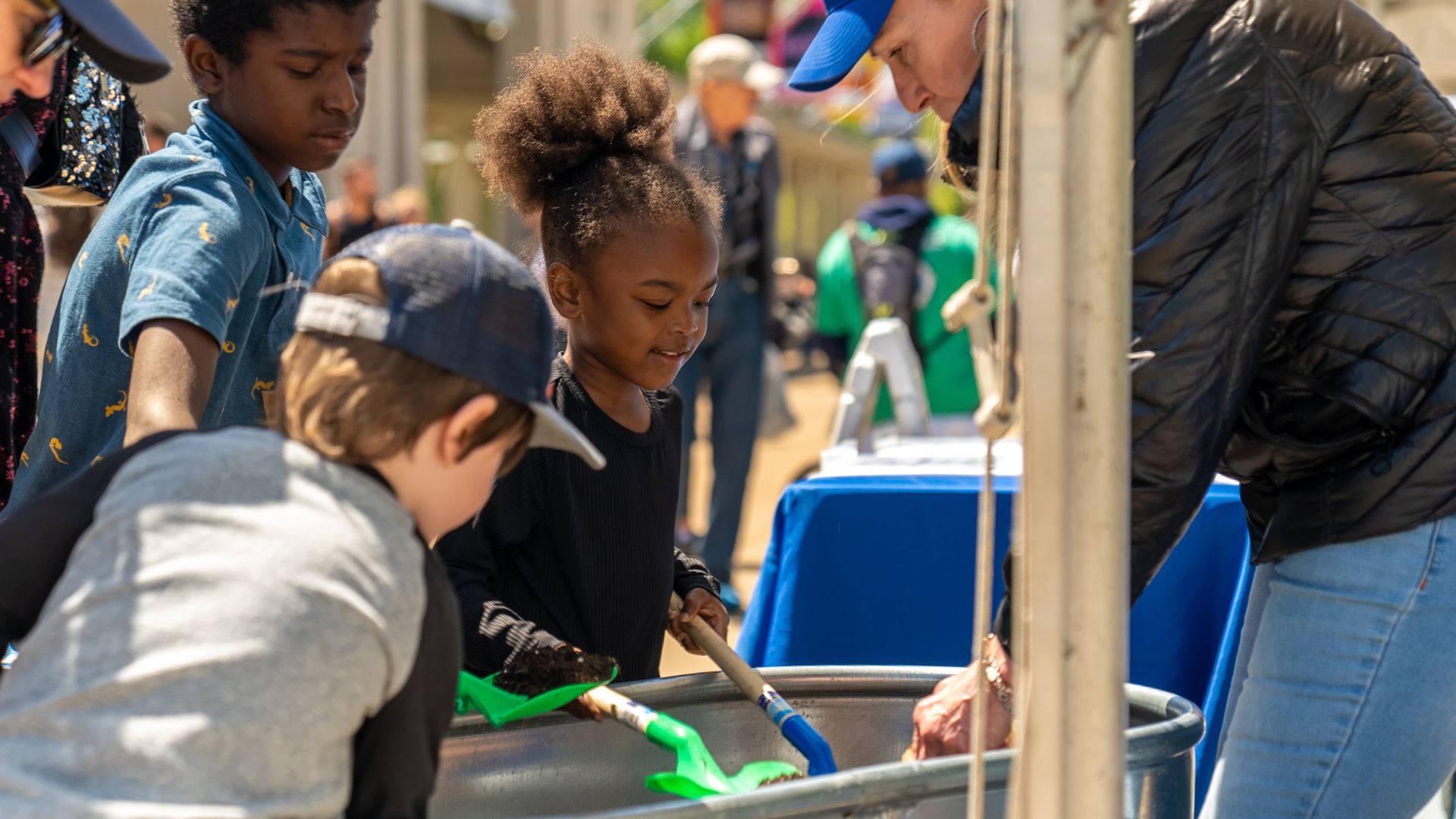 Kids play in the dirt at Earth Day in St. Louis.