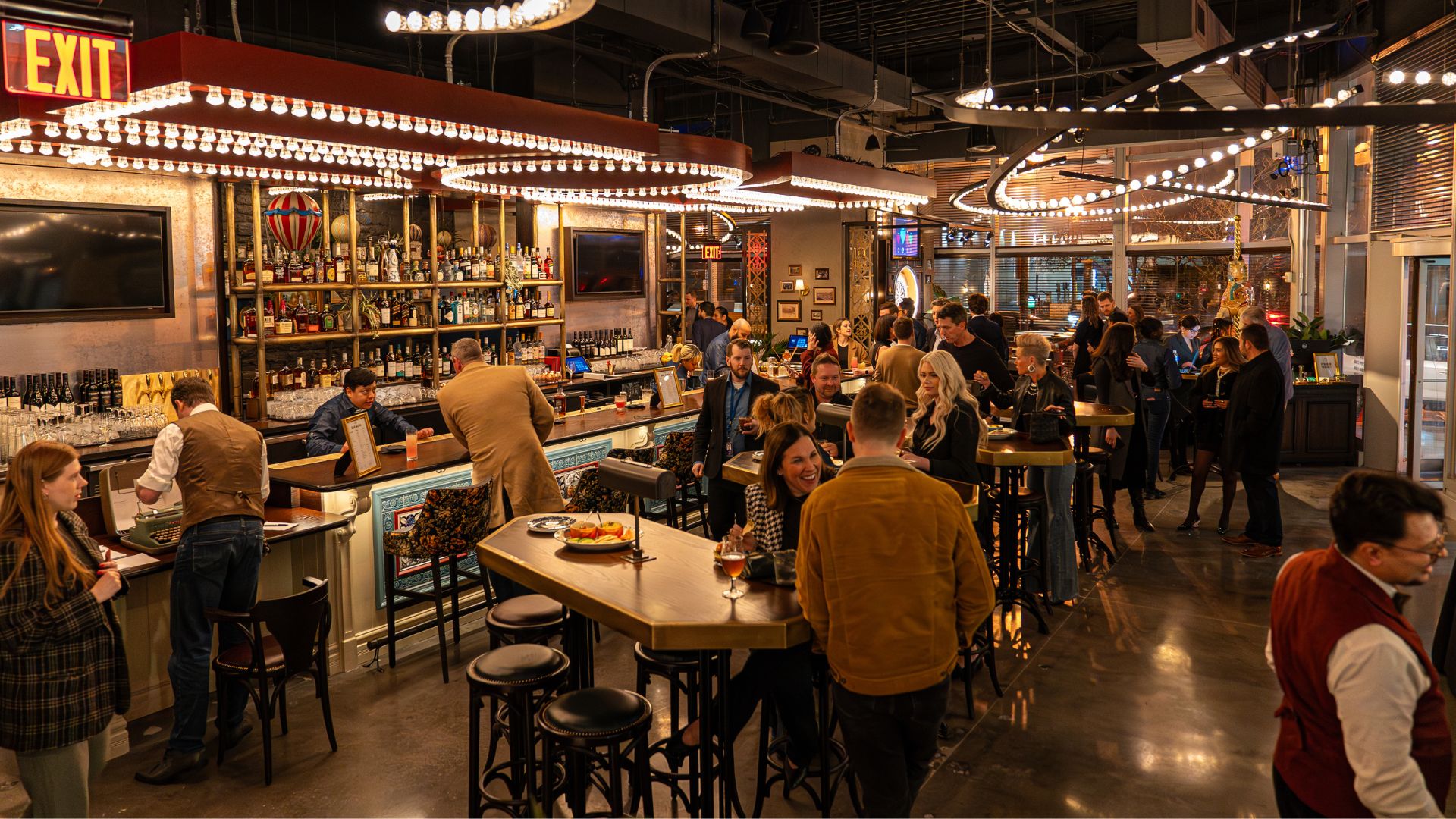 A crowd of people enjoy signature cocktails at Flight Club in Clayton.