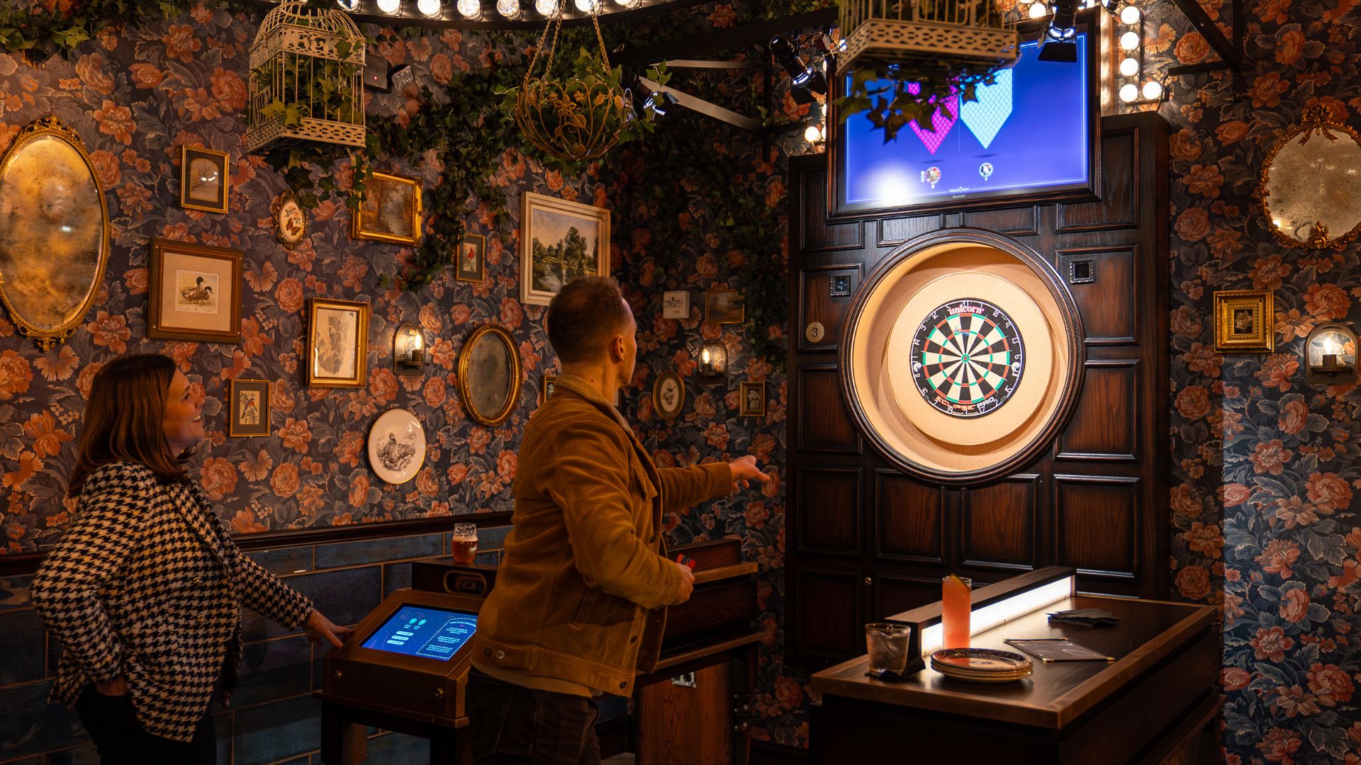 A couple plays darts at Flight Club in St Louis.