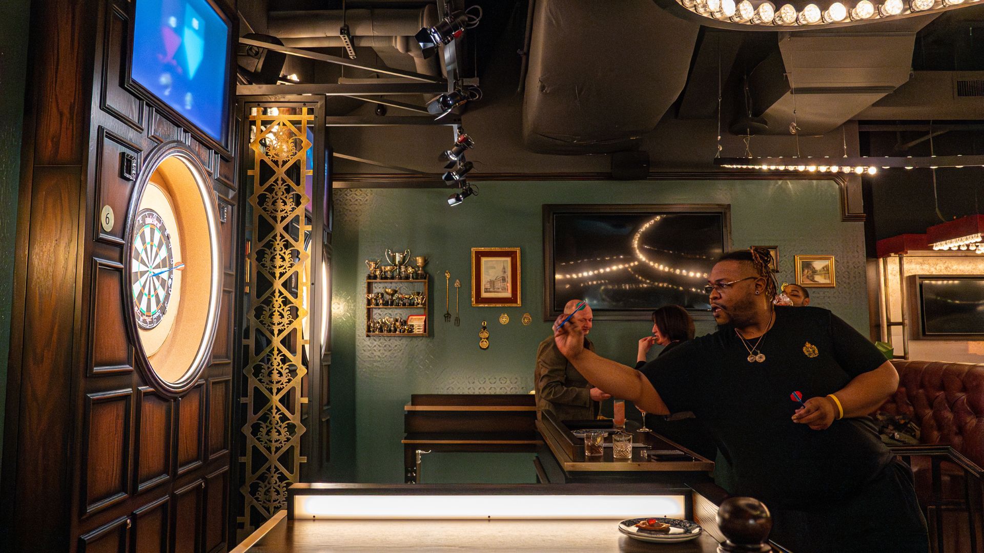 A man throws darts at Flight Club in St Louis.