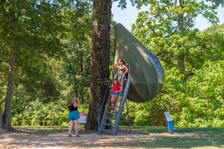 Kids pose for a photo with one of the al fresco sculptures at Laumeier Sculpture Park in St Louis.