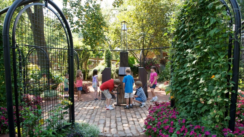 A group of kids interact with the plants at the Missouri Botanical Garden.