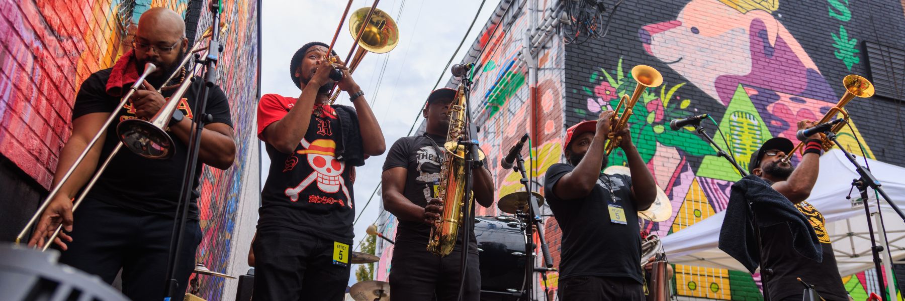 A brass band plays among the murals of Grand Center during Music at the Intersection, which features some of the best summer concerts in St Louis.