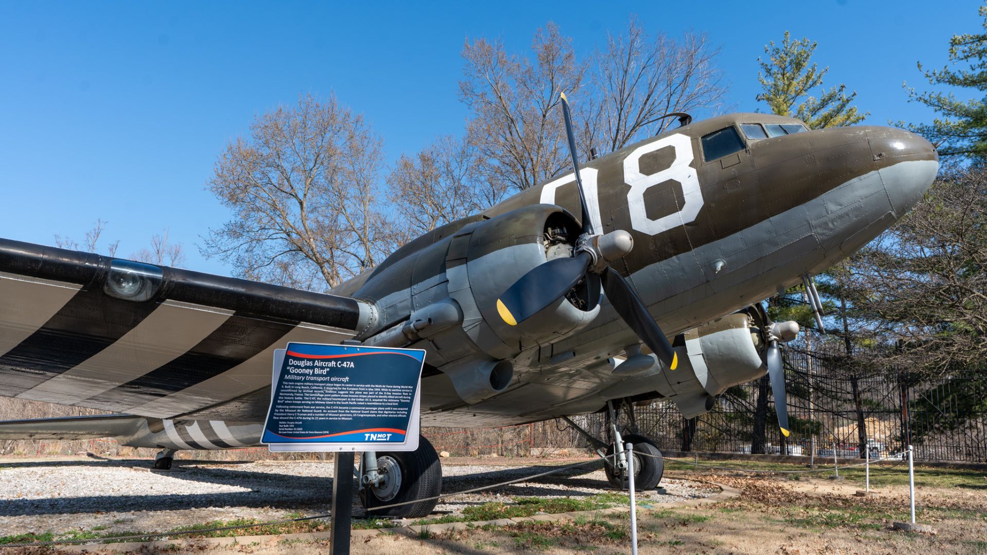This twin-engine aircraft is painted in camouflage with distinctive invasion stripes to identify it as an Allied plane.