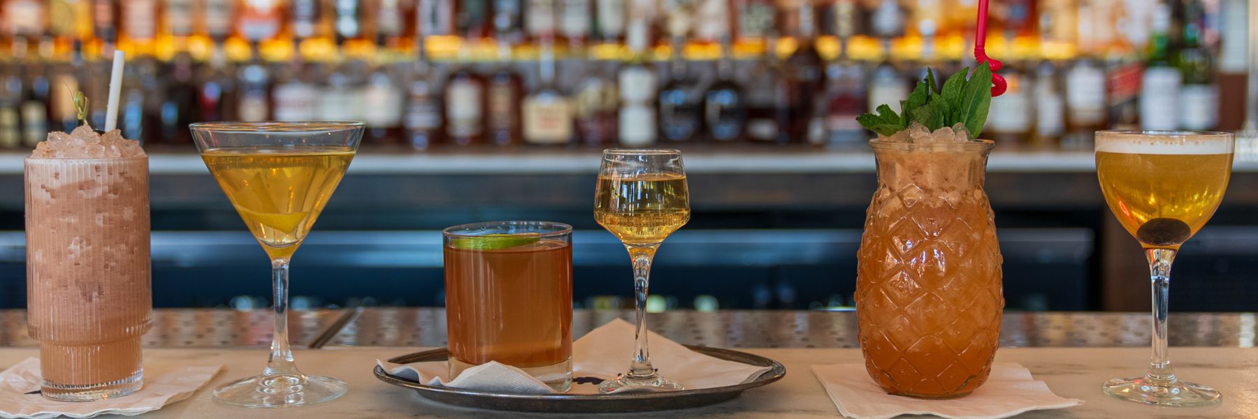 Cocktails line the bar at Olive and Oak.