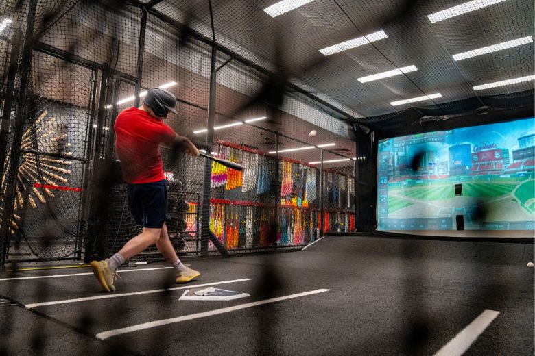 A teenage boy hits a baseball in the batting cages at the Rawlings Experience in St Louis.
