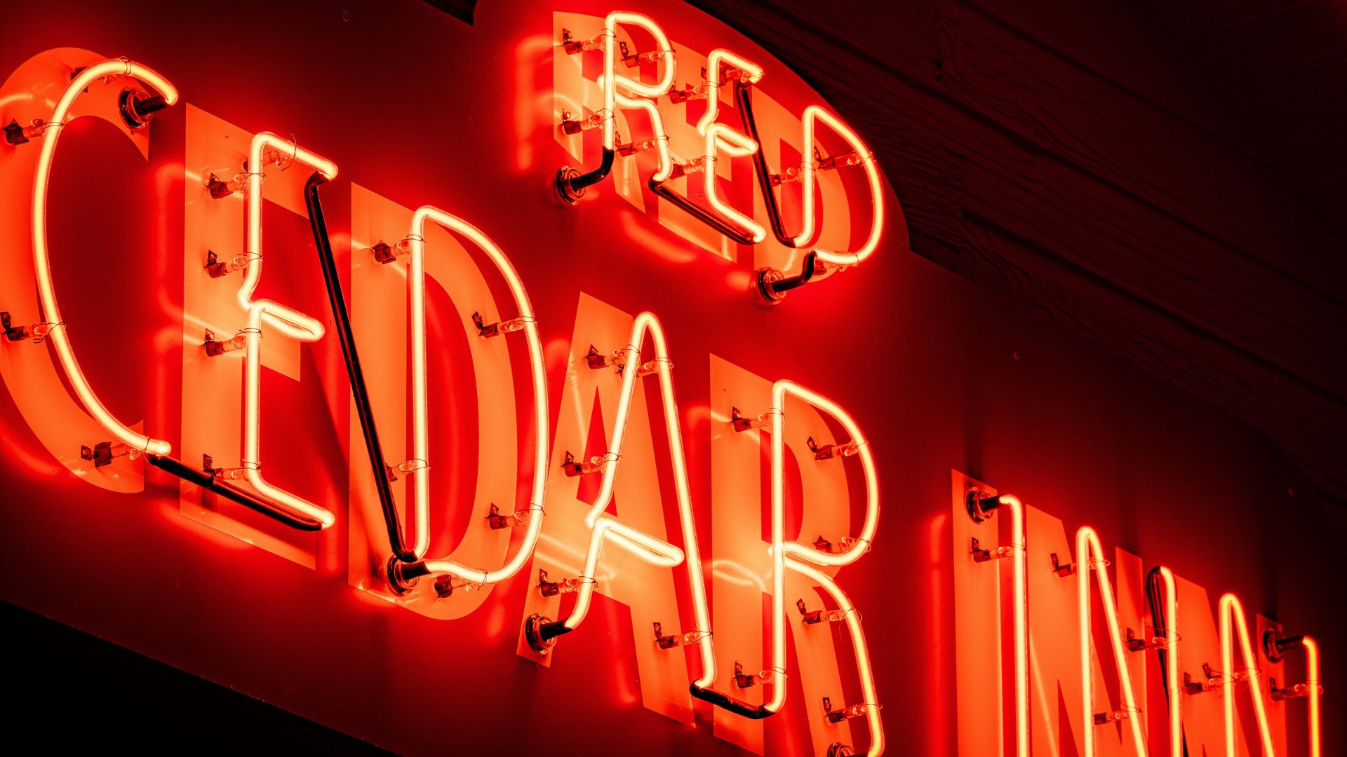 The neon sign at Red Cedar Inn glows red along Route 66 in St Louis.