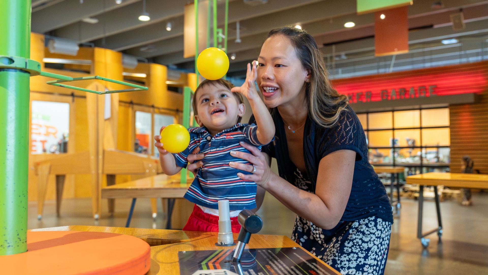 A mother and her young son make balls float in the air at the Saint Louis Science Center.