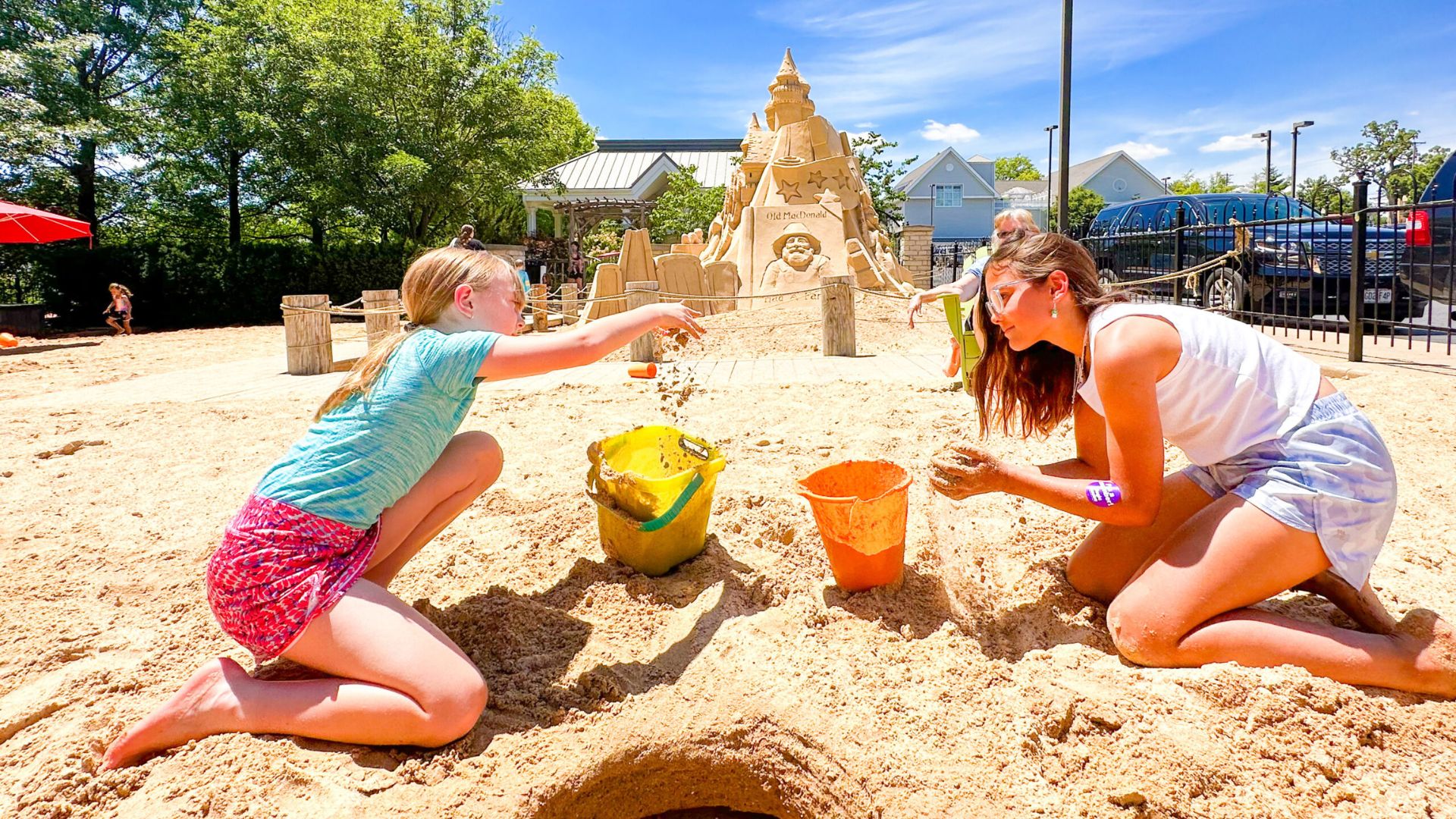 A mother and daughter play in the sand at The Magic House during summer in St Louis.