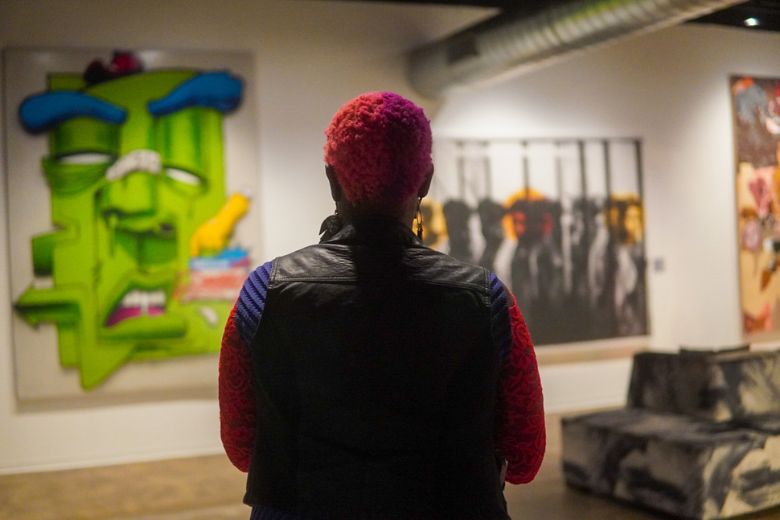 An art enthusiast looks through the gallery at Sophie's Artist Lounge.
