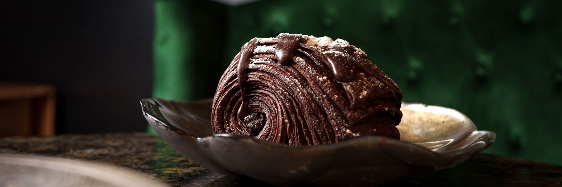 At La Pâtisserie Chouquette, The Darkness is comprised of flaky chocolate dough, two chocolate batons, rich chocolate drizzle and pink Himalayan sea salt.