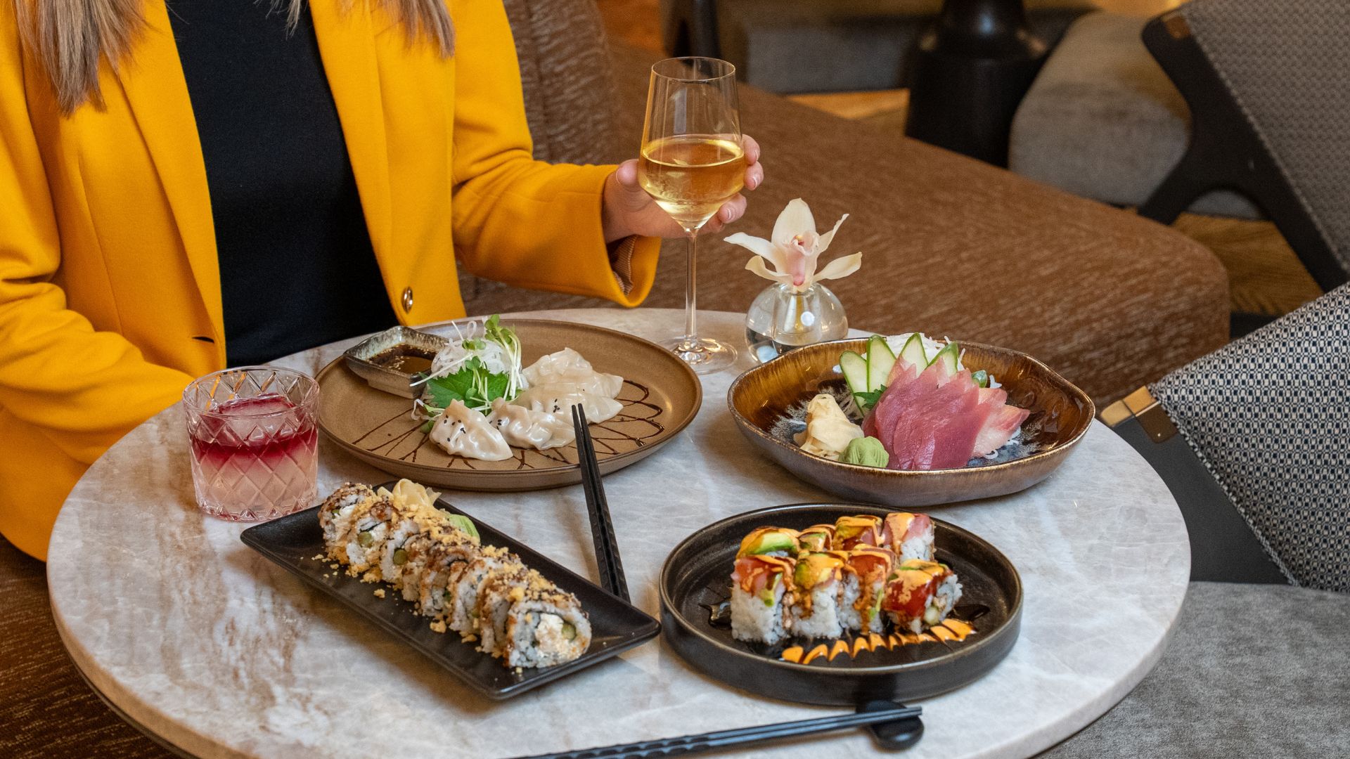 A hotel guest enjoys a spread of sushi.