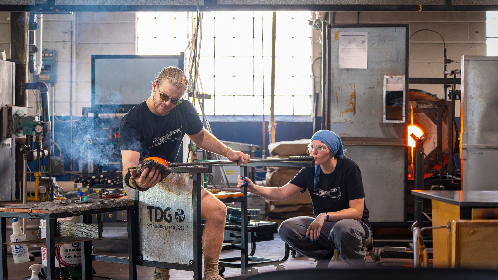 A team blows glass art at Third Degree Glass Factory, a unique St Louis event venue.