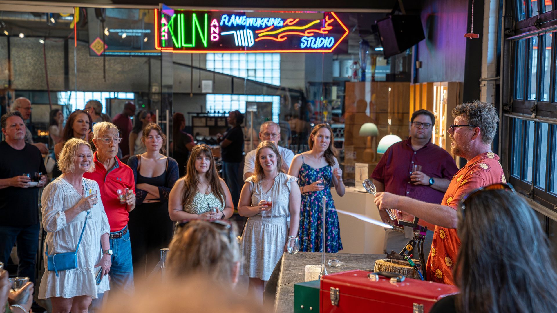 A crowd watches a glassblowing demonstration at Third Degree Glass Factory.