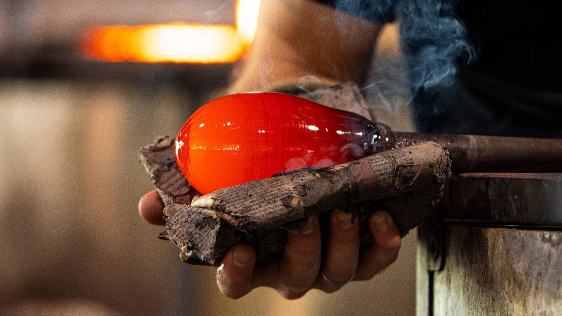A glassblower works in the studio at Third Degree Glass Factory in St Louis.