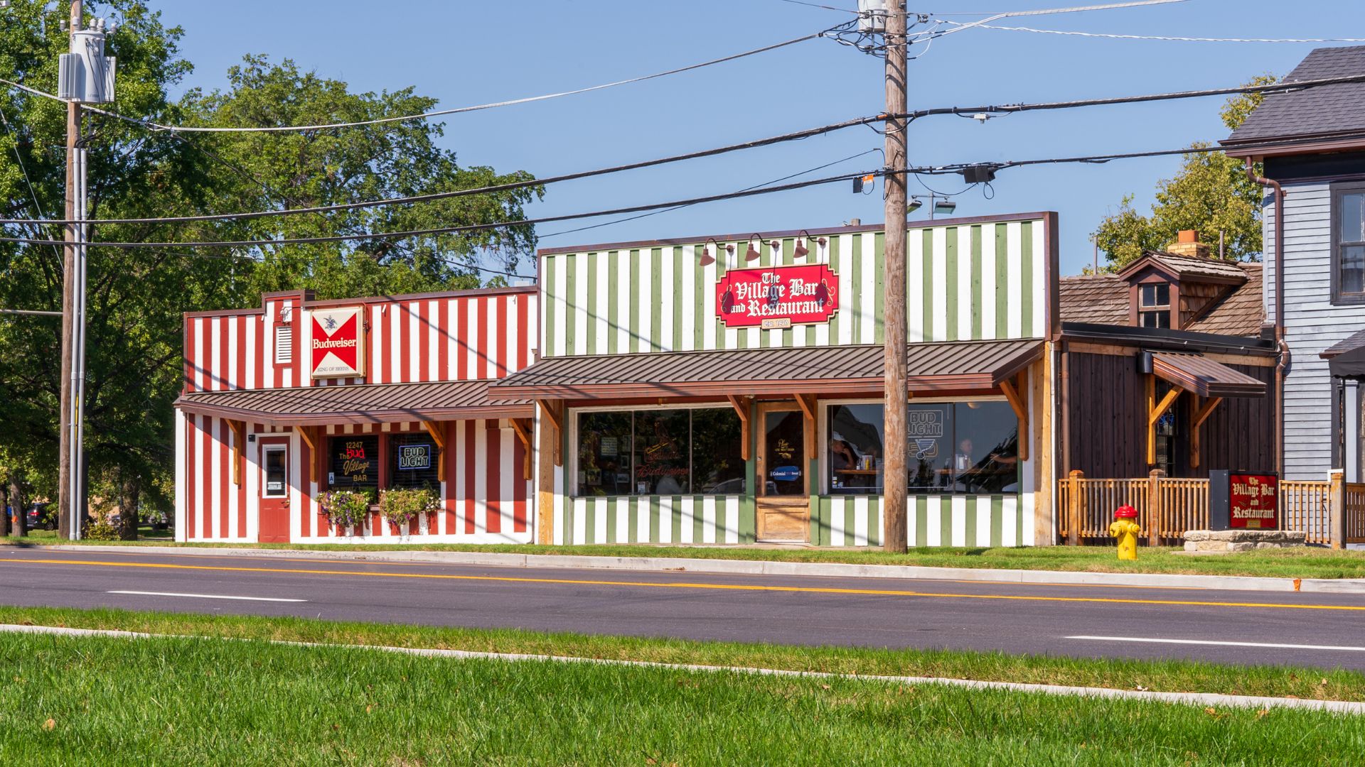 Village Bar is tucked into a red-and-white-striped building along Route 66 in St. Louis.